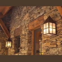 Carriage™ Lantern Exterior Wall Lights on Rustic Exterior