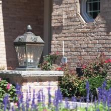 French Country™ Exterior Pier Light Atop a Low Wall For Landscape Lighting