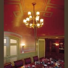 Dining Room of a Historic Inn Lit with a Golden Gate™ Two Tier, Twelve Light Chandelier