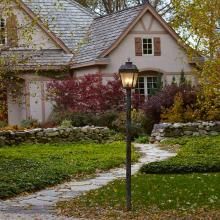 A Provincial™ 11" Wide Exterior Post Light Provides Path Lighting
