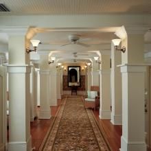 Corridor of Historic Resort and Spa lit with Shoreland™ Sconces