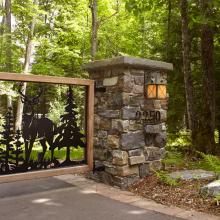 Rustic Style Front Gate Lit with Stonehaven™ Lantern 14" Wide Exterior Wall Lights on Piers.