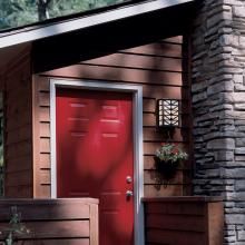 Prairie Style Cabin Exterior Entry Lit with Sunrise Center™ Exterior Wall Light